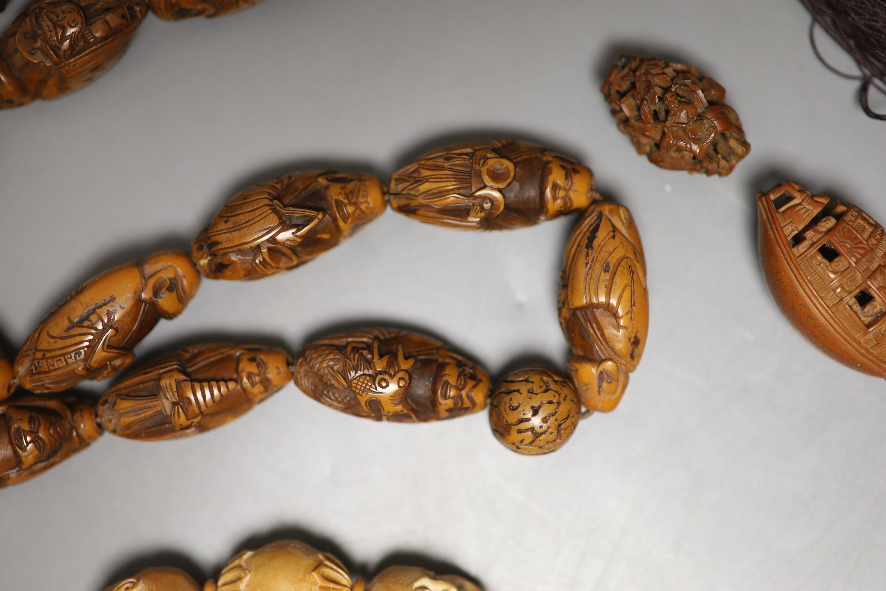 A coquilla nut necklace, bracelet and two small ornamental carvings